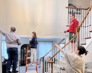 Family and my husband hanging the painting.